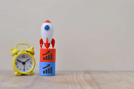 Yellow clock, rocket and graph symbols. Business startup, new idea and new project concept.の写真素材