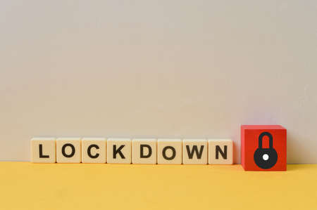 Red wooden block with padlock symbol and LOCKDOWN wordsの写真素材