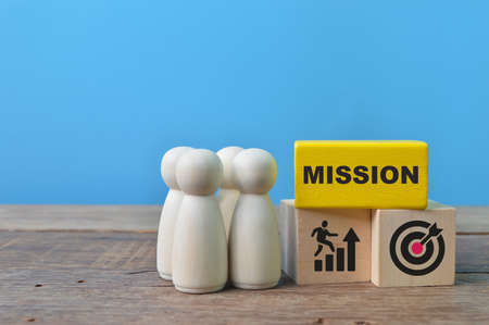 Wooden people figure and wooden blocks with text MISSIONの写真素材