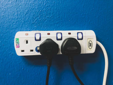 Klang, Malaysia: October 26, 2021- Blue wall with electric sockets and plugsのeditorial素材
