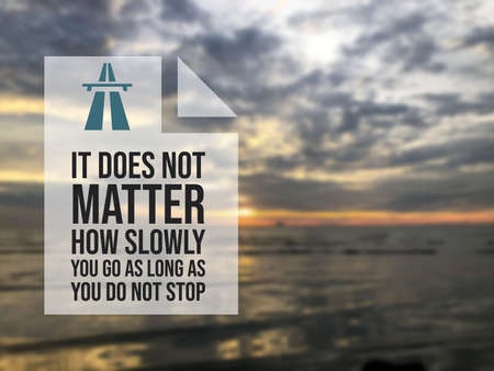 Motivational quote written with phrase IT DOES NOT MATTER HOW SLOWLY YOU GO AS LONG AS YOU DO NOT STOPの写真素材