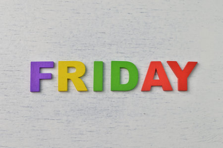 Colorful wooden alphabet with text FRIDAY. A happy Friday conceptの写真素材