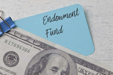Money banknote and blue card with text ENDOWMENT FUNDの写真素材