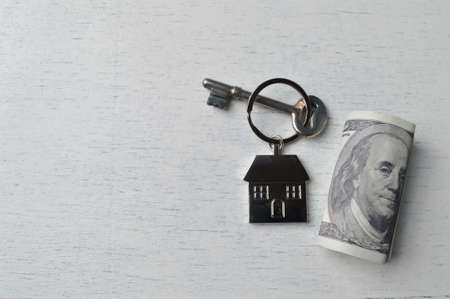 Money banknote and toy house with copy space.