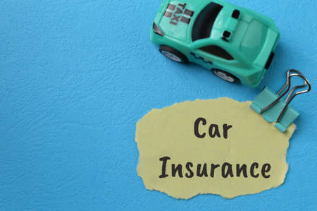 Toy car and torn paper with text CAR INSURANCEの写真素材