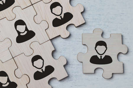 Choosing good employer leader. Wooden jigsaw puzzle with people figuresの写真素材