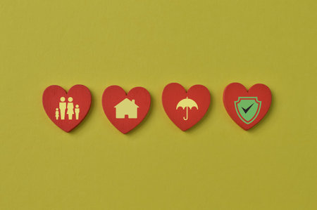 Insurance coverage concept. Wooden love shapes with house, people, umbrella and shield symbols.の写真素材