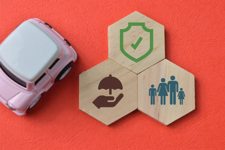 Car and wooden hexagon with safety and insurance protection symbolの写真素材