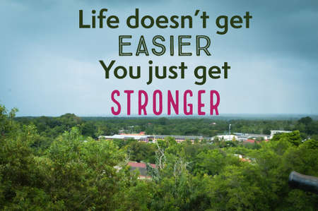 Inspirational and motivational quote written with LIFE DOESN'T GET EASIER, YOU JUST GET STRONGERの写真素材