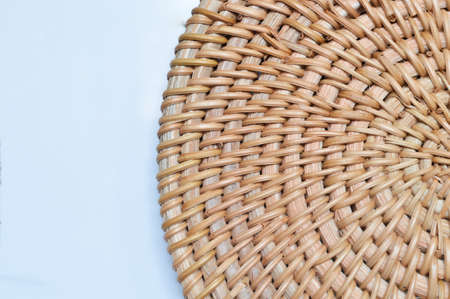 Close up view of wooden pad for hot dishes isolated on a white backgroundの写真素材