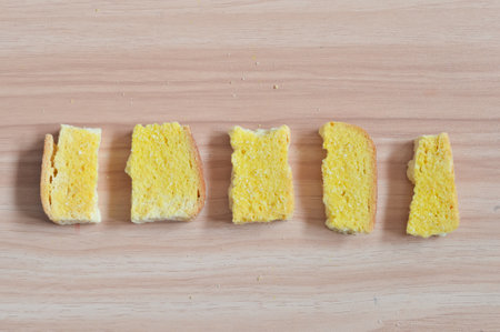 Sliced butter bread on wooden background