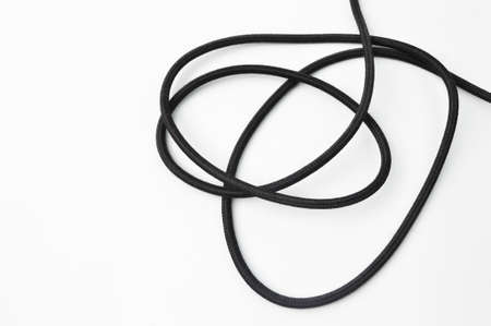 A black wire cable isolated on a white backgroundの写真素材