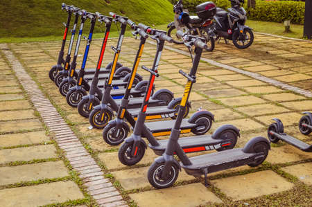 An electric scooter in a row at the park. Vintage imageの写真素材