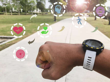 Hand wearing smartwatch with health symbols. Healthy lifestyle and smart health concept.