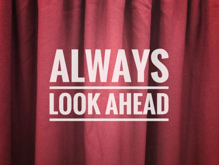 Red curtain background with text ALWAYS LOOK AHEADの写真素材