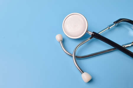 Stethoscope isolated on a blue background with copy space. Health concept.の写真素材