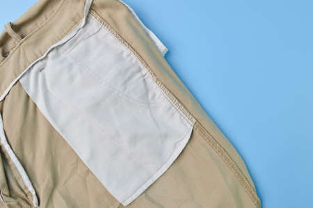 Close up view of a pant pocket isolated on a blue background. Fashion design concept