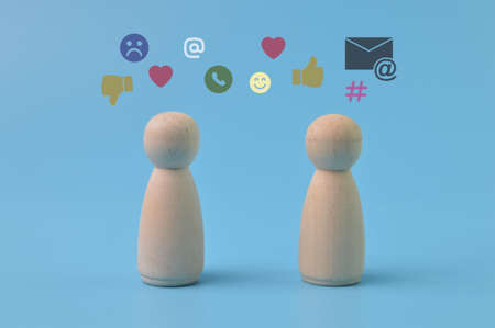 Wooden doll figure with communication symbols. Social media concept.の写真素材