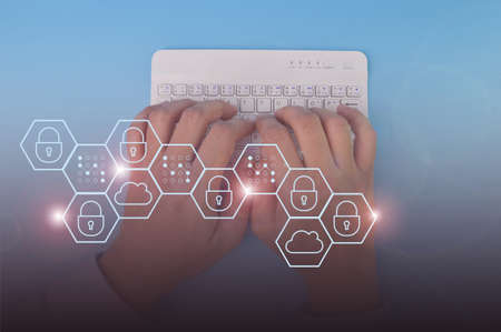 Hand pressing button on the computer keyboard with data protection, information safety and...