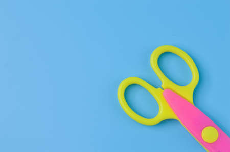 Scissors isolated on a blue background. School and office suppliesの写真素材