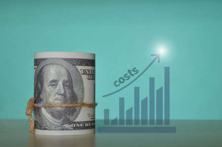 Money banknotes and graph with text COSTSの写真素材