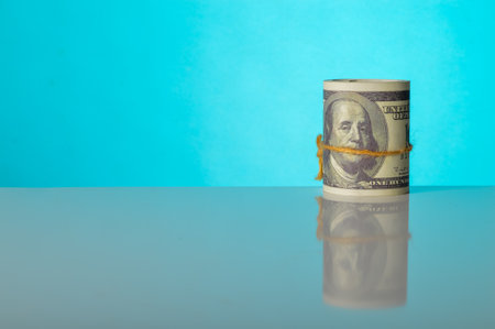 Money banknotes isolated on a blue background. Copy space for the text