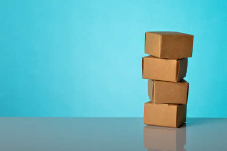 Stack of cardboard boxes isolated on a blue background. Stock market and commodity concept.の写真素材