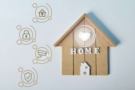 Toy house with internet, security, cctv or video surveillance and light bulb symbolsの写真素材