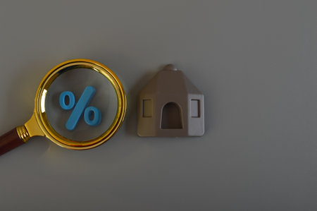 Magnifying glass, percentage symbol and house model. Housing mortgage and risks.の写真素材