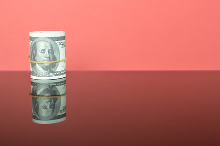 USD money banknotes isolated on a red background. Copy space for the text.の写真素材