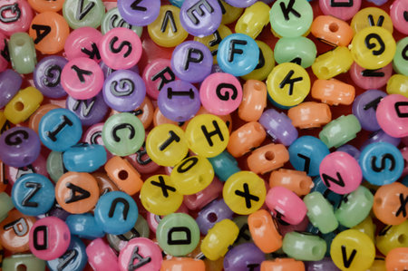Colorful alphabet beads with letters. Close up view.