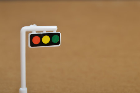 White toy traffic light isolated on a brown background.
