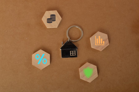 House keychain with graph, insurance, percentage and money symbols.の写真素材