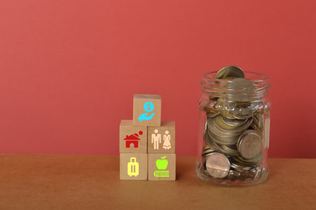 Bunch of coins in a glass jar with saving, property, wedding, travel and education symbols.
