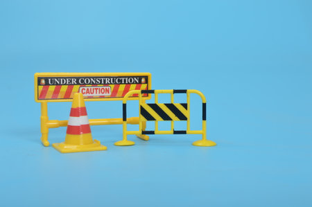 Traffic road barrier: A warning barrier for road closure and website under construction page. Includes warning and stop signs, roadwork, traffic barricades, cones, and safety barricades.の写真素材