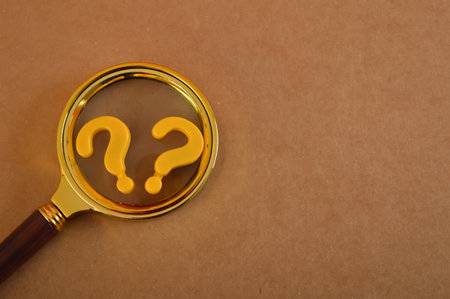 The concept of counseling for problems, solutions, and confusion is symbolized by a question mark on magnifying glass.の写真素材