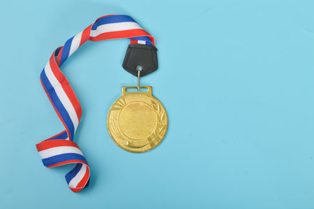 An empty gold medal with copy space is a representation of the concept of celebration and ceremony, as well as a symbol of victory and sporting achievements.の写真素材