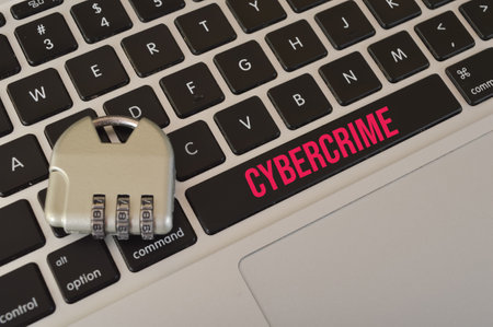 Padlock and computer keyboard written with CYBERCRIME