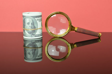 Magnifying glass and money banknotes. Financial market, investment earning or money management analysis, economic growth, stock exchange market report conceptの写真素材