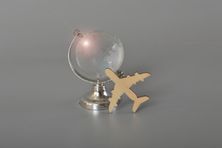 Flight and world globe with flare.World travel globe concept isolatedの写真素材