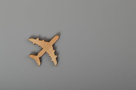 Wooden airplane isolated on a grey background.の写真素材