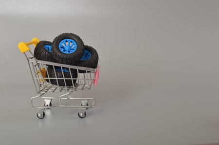 A photo capturing car wheels placed in a shopping cart, symbolizing the thriving car wheel industry worldwideの写真素材