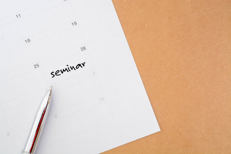 The timetable paper sheet displays the seminar date, which must be followed and saved.の写真素材