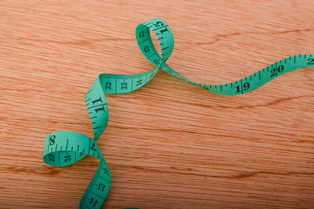 Top view of green measuring tape with copy space. diet, weight loss and fasting concept.の写真素材