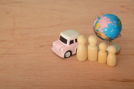 Toy car, world globe and family figures. Travel concept.の写真素材