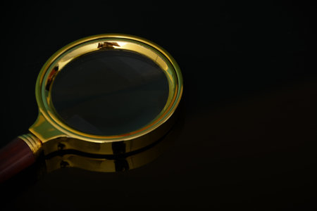 Magnifying glass isolated on a black background. Copy space.の写真素材