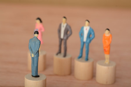 The businessman, standing in a row with his team, listened carefully as the boss led a discussion about an important decision for the companyの写真素材