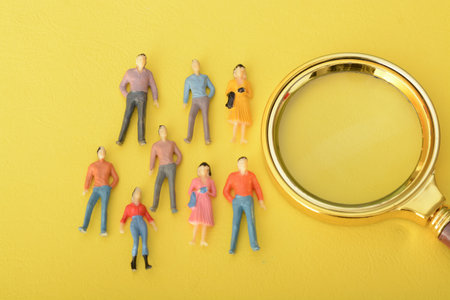a magnifying glass in hand, the group of staff embarked on a thorough search, determined to find the most suitable candidate to hire for the job position.の写真素材