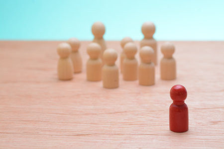 The wooden staff figures stood in unison, representing synergy among teammates, symbolizing the cohesive force within the company, as they awaited guidance from their boss.の写真素材