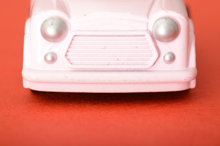 The close-up of a toy retro car highlights its miniature charm, offering a glimpse into the vintage design and craftsmanship that captures the essence of a simpler automotive era.の写真素材
